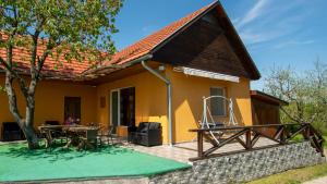a house with a pitched roof and a patio at Dombtető Vendégház in Sátoraljaújhely