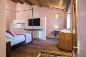 a bedroom with a bed and a tv on the wall at Dimora del Leone Gaeta in Gaeta