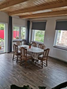 a dining room with a table and chairs at Halász Vendégház in Szilvásvárad