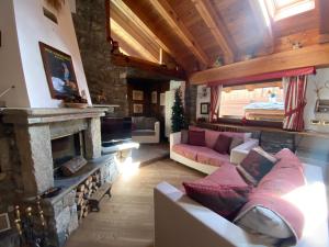 a living room with a couch and a fireplace at Chalet Cretaz in Valtournenche