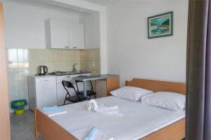 um quarto com uma cama e uma pequena cozinha em Apartments Ivica - Beachfront em Drvenik