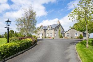 a large house with a driveway at Drum Manor in Hillsborough