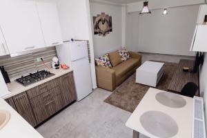 a kitchen and living room with a refrigerator and a couch at Home sweet home 2 in Bacău