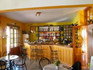 a bar in a restaurant with tables and chairs at Liberty II in Agia Marina Aegina