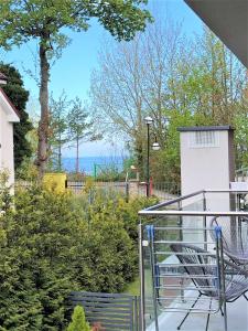 a balcony with a bench and a view of the ocean at Raval Apartments - Fresh Turquoise in Rewal