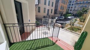 a balcony of a building with a green bench at Boutique Hotel Nice Côte d'azur in Nice