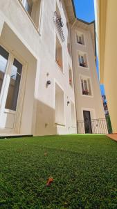 a large building with a yard with green grass at Boutique Hotel Nice Côte d'azur in Nice