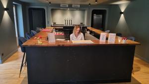 a woman sitting at a bar in a room at Boutique Hotel Nice Côte d'azur in Nice