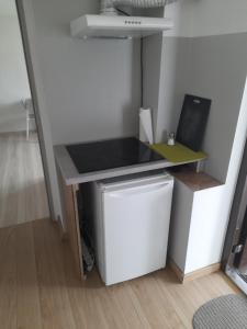 a small desk in a room with a small refrigerator at Villa Belveder in Poznań
