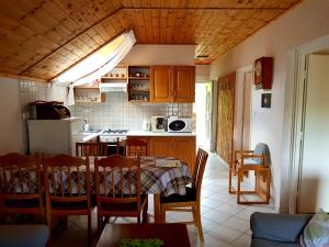 a kitchen with a table and a dining room at Borostyán Apartmann in Balatonföldvár