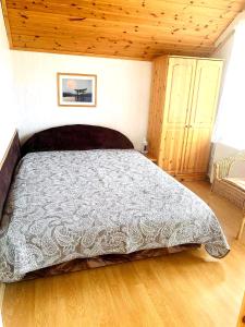 a bedroom with a bed with a gray comforter at Borostyán Apartmann in Balatonföldvár +36 photos