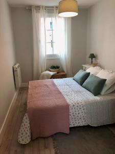 a bedroom with a large bed and a window at Casa Casco Antiguo A Guarda in A Guarda