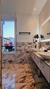 a bathroom with two sinks and a large mirror at Boutique Hotel Nice Côte d'azur in Nice