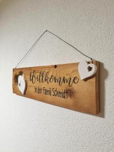 a wooden sign with hearts hanging on a wall at Bi de Furre in Reckingen - Gluringen