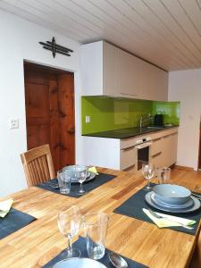 a dining room table with plates and wine glasses at Bi de Furre in Reckingen - Gluringen +20 photos