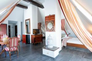 a bedroom with a bed and a desk and a clock at Hotel Astoria am Urachplatz in Stuttgart