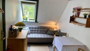 a living room with a couch and a window at Borgdal in Silkeborg