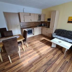 a living room with a couch and a table at Ferienwohnung am Spitzberg in Suhl