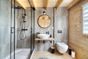 a bathroom with a shower and a sink and a toilet at Wood Village in Winiec +24 photos