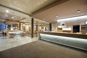 a lobby with a bar and a dining room at Hotel SOREA URÁN in Tatranská Lomnica