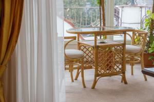 a glass table and chairs on a balcony at Hotel Premyer in Truskavets