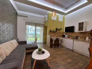 a living room with a couch and a table at Tošić apartman in Sombor