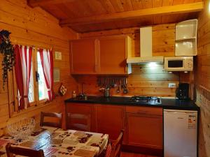 a kitchen with wooden walls and a table with a table sidx sidx at Chalet Lake Lugano, Vienna 18 in Porlezza