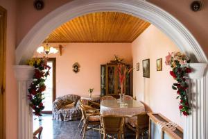 an archway in a living room with a table and chairs at koula's apartments in Vasiliká