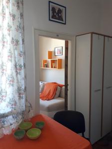 a room with a table and a bedroom with a bed at cozy hikers flat in Belgrade