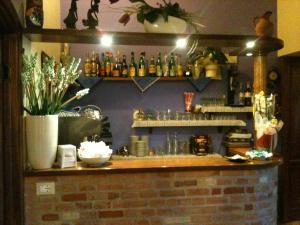 a bar in a restaurant with a brick wall at Agriturismo Lo Sgorzolo in Pergola