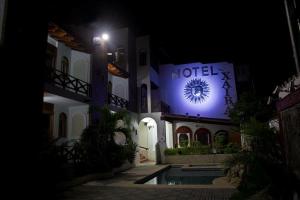 a hotel at night with a lit up sign at HOTEL VILLAS XAIBA in Puerto Escondido