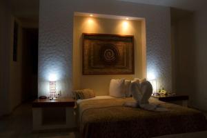 a hotel room with a bed and two night stands at HOTEL VILLAS XAIBA in Puerto Escondido