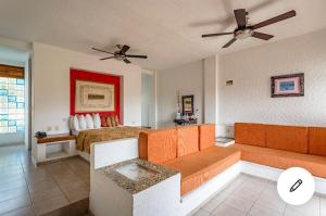 a living room with a couch and a bed at HOTEL VILLAS XAIBA in Puerto Escondido