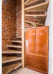 a room with a wooden cabinet and a brick wall at HOTEL VILLAS XAIBA in Puerto Escondido