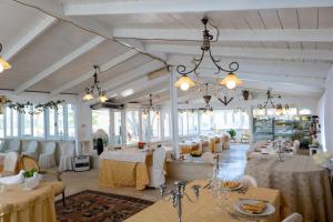 a large room with tables and chairs in it at TORRE PINTA Masseria Medioevale in Otranto
