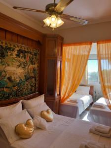 a bedroom with two beds with hearts on the pillows at Palio Villa in Paleo Tsifliki