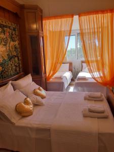 a bedroom with two beds with towels on them at Palio Villa in Paleo Tsifliki