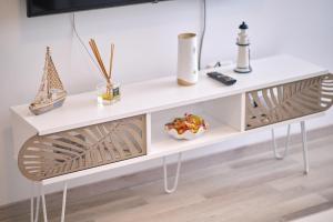 a white console table in a living room at Alina Lake View Apartment in Mamaia