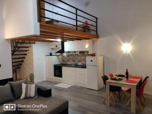 a kitchen and a living room with a table and a dining room at Apartment Karma in Zadar