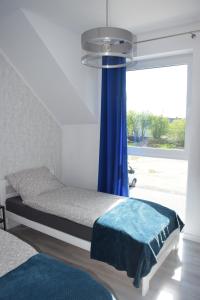 Posteľ alebo postele v izbe v ubytovaní Domek pod świerkami - "Apartamenty świerkowe"
