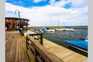 a dock with boats docked in the water at Apartament BlueBay in Puck