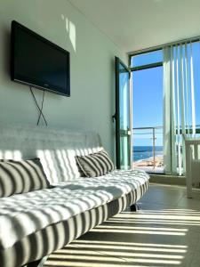 a living room with a couch and a flat screen tv at BEACH APARTMENT no 17 in St. St. Constantine and Helena