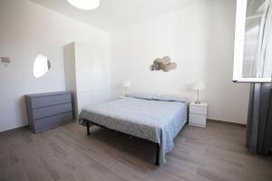 a bedroom with a bed and a dresser and a mirror at GLBapartments in Capo dʼOrlando