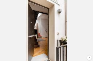 a hallway with a door leading to a stairway at Bijoux Luxury Apartment in Old Town in Bari