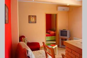 a living room with a couch and a television at Apartman Budva Ivana in Budva