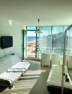 a living room with a bed and a view of the ocean at BEACH APARTMENT no 17 in Saints Constantine and Helena