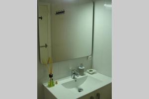 a bathroom with a sink and a mirror at Apartamento al lado de la playa con parking y jardín in Platja  d'Aro +11 photos