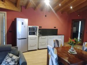 a kitchen with a white refrigerator and a table at casa nonni in Mantova