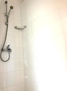 a shower with a shower head in a bathroom at BEACH APARTMENT no 17 in Saints Constantine and Helena