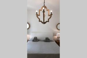 a bedroom with a chandelier hanging from the ceiling at Luxury Villa Mariachiara in Monopoli